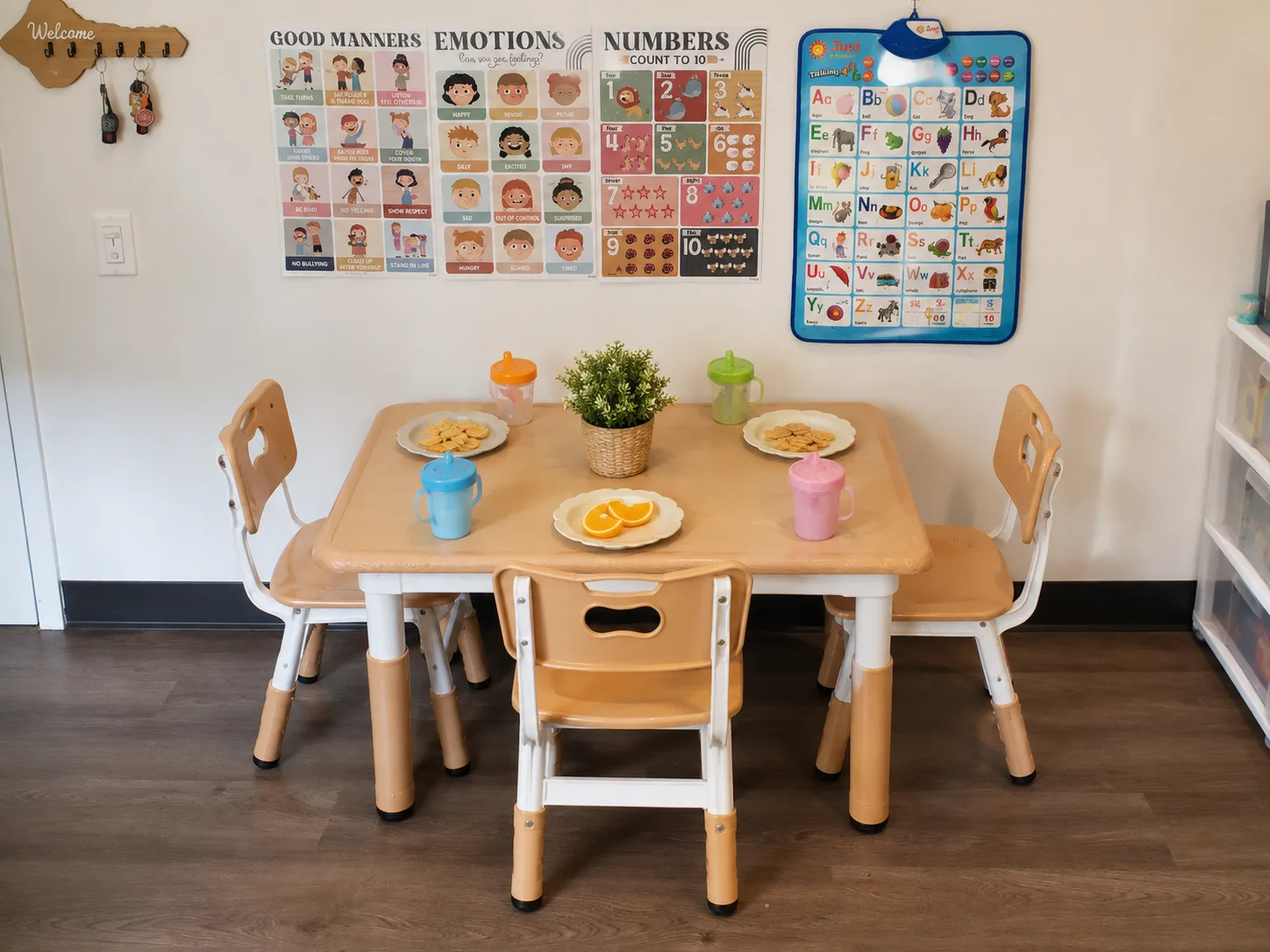 A small table set with snacks, fruit, and children's cups at T.L.C. Footprints